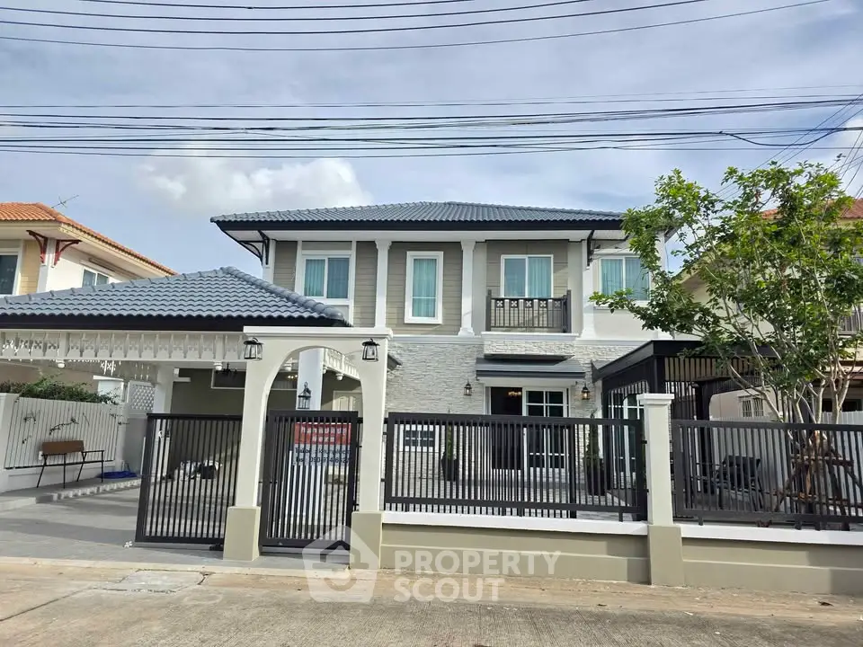 Stunning two-story modern house with gated entrance and spacious driveway in a serene neighborhood.