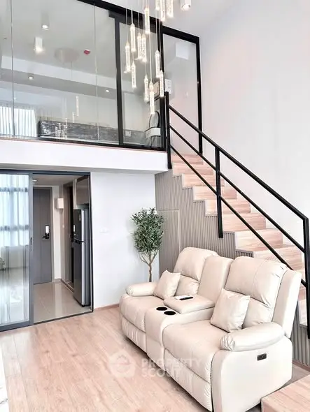 Modern duplex living room with elegant staircase and cozy seating area