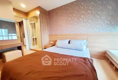 Modern bedroom with elegant wallpaper and cozy bedding in a stylish apartment.