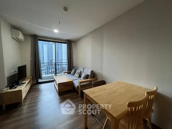 Modern living room with balcony view in high-rise apartment