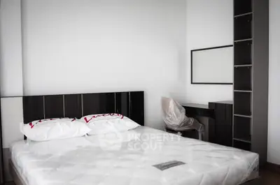 Modern minimalist bedroom with sleek furniture and comfortable mattress, perfect for a restful retreat.