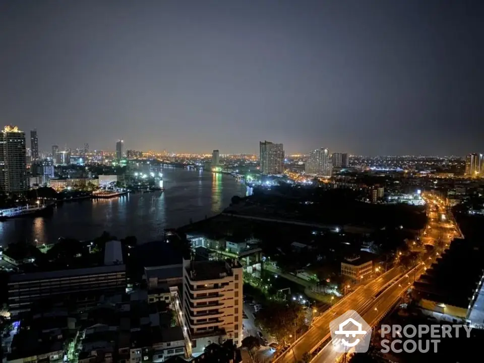 Stunning cityscape view from high-rise apartment overlooking river at night