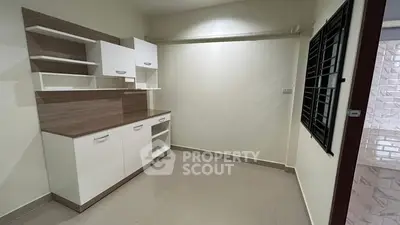 Spacious storage room with modern cabinetry and tiled flooring