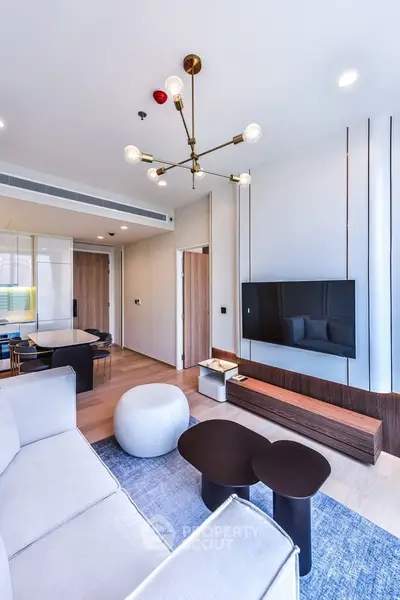 Modern living room with stylish lighting and sleek TV setup in a contemporary apartment.