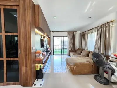 Spacious living room with modern decor and large windows for natural light