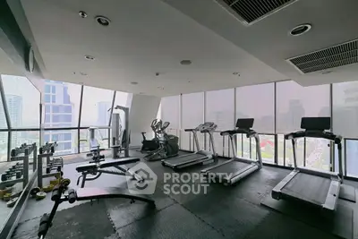 Modern gym with panoramic city views and state-of-the-art equipment.