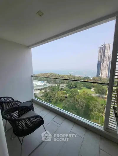 Spacious balcony with stunning city and ocean view, perfect for relaxation and enjoying the scenery.