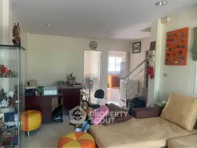 Cozy living room with modern decor and open layout, featuring a comfortable sofa and stylish accents.