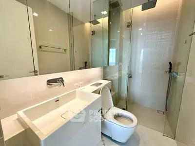 Modern bathroom with sleek fixtures and glass shower enclosure