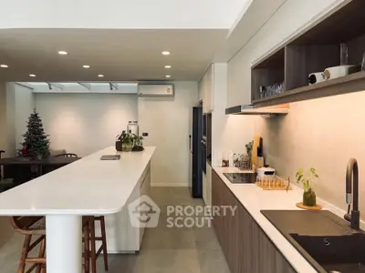 Modern kitchen with sleek countertops and open layout, perfect for culinary enthusiasts.
