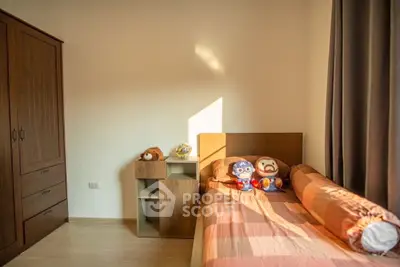Cozy bedroom with wooden furniture and plush toys, perfect for a child's room.