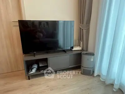 Modern living room with sleek TV setup and air purifier, perfect for cozy entertainment.