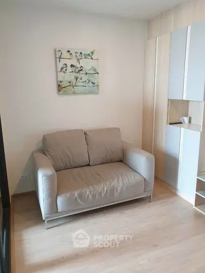 Cozy living room with modern decor and comfortable seating in a stylish apartment.