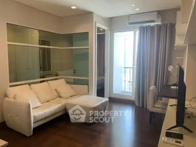 Modern living room with cozy white sofa and balcony access in stylish apartment.