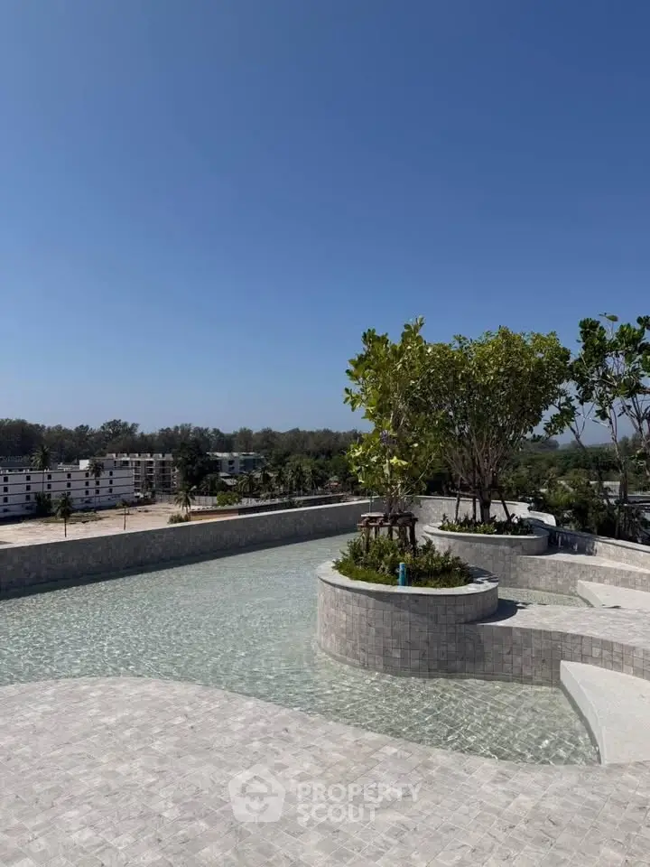 Stunning rooftop pool with panoramic views and lush greenery, perfect for relaxation and leisure.