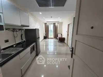Modern open-layout kitchen with sleek appliances and spacious living area.