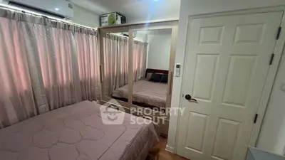 Cozy bedroom with mirrored wardrobe and soft lighting