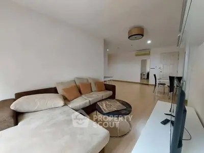 Spacious living room with modern furniture and open layout, ideal for comfortable living.