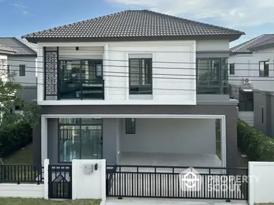 Modern two-story house with spacious driveway and contemporary design