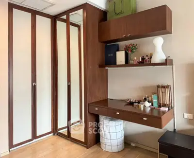 Stylish bedroom with wooden wardrobe and modern vanity desk, perfect for organizing and relaxing.