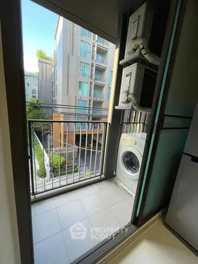 Modern apartment balcony with washing machine and city view, perfect for urban living.