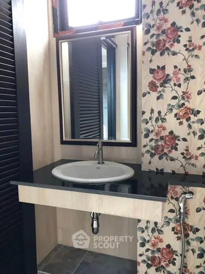 Chic bathroom with floral accent wall and modern sink design