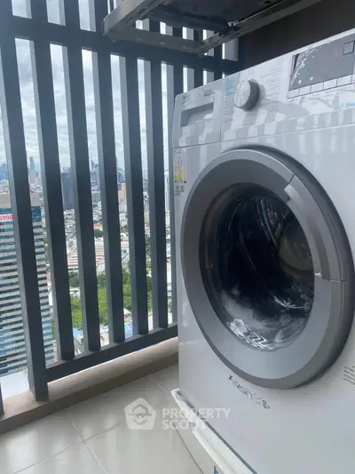 Modern washing machine on a high-rise balcony with stunning city view.
