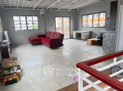 Spacious living room with modern decor and large windows offering natural light.
