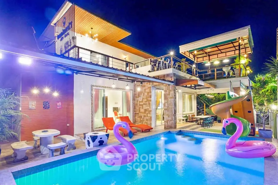 Luxurious modern villa with pool and vibrant night lighting, featuring unique architecture and outdoor leisure area.