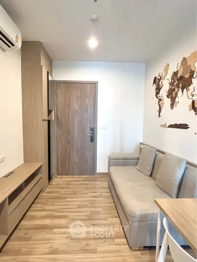 Modern living room with wooden flooring and stylish decor in a cozy apartment.