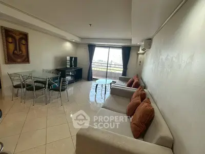 Spacious living room with modern furniture and large windows offering natural light.