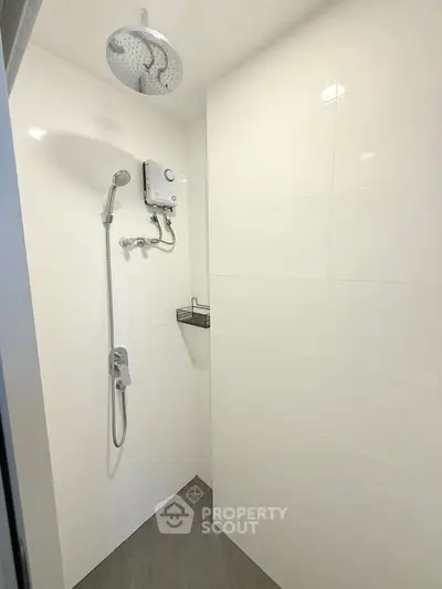 Modern bathroom with sleek shower fixtures and white tiled walls