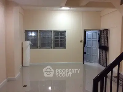 Spacious unfurnished room with glossy tiled floor and secure window bars