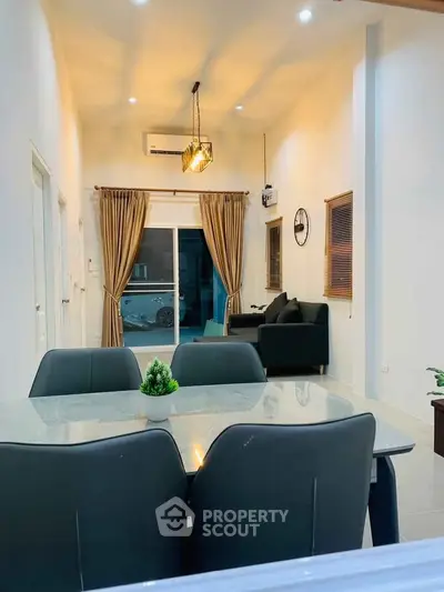 Modern living room with elegant dining area and cozy seating, perfect for family gatherings.