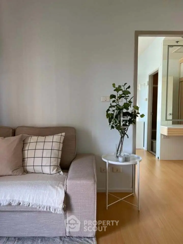 Cozy living room with modern decor and natural light, featuring a stylish sofa and elegant side table.