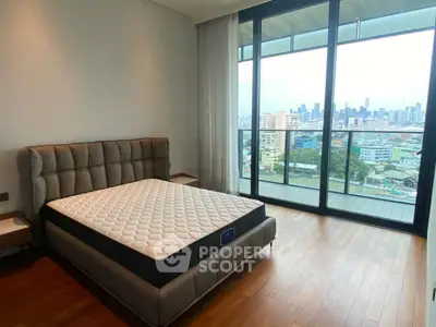 Spacious bedroom with city view and large balcony in modern apartment