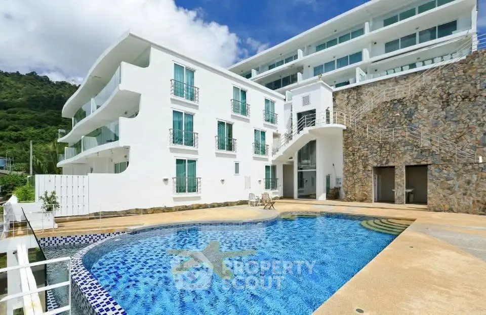 Luxurious modern building with stunning pool and scenic views, perfect for upscale living.