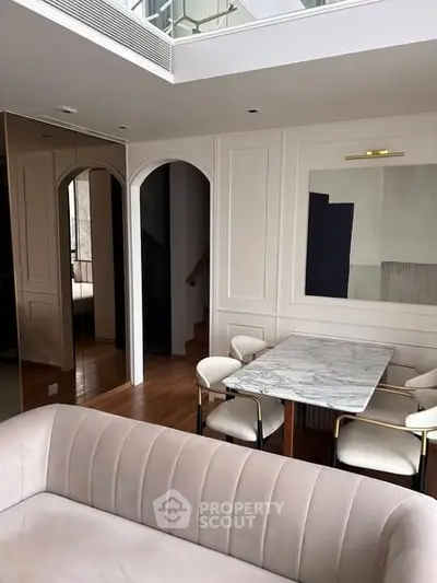 Elegant living room with modern dining area and stylish decor