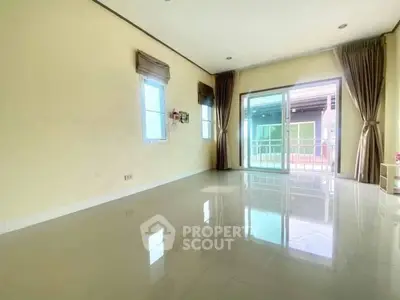 Spacious empty room with large windows and balcony access, perfect for customization.