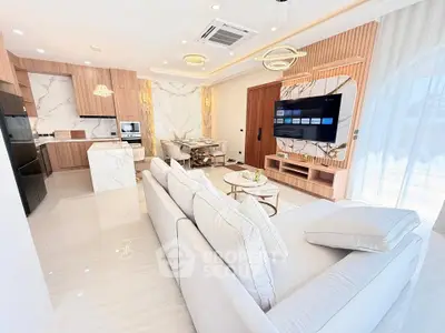 Luxurious open-plan living room with modern kitchen and elegant decor