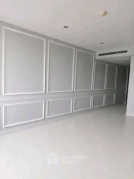 Spacious modern interior with elegant wall paneling and minimalist design.