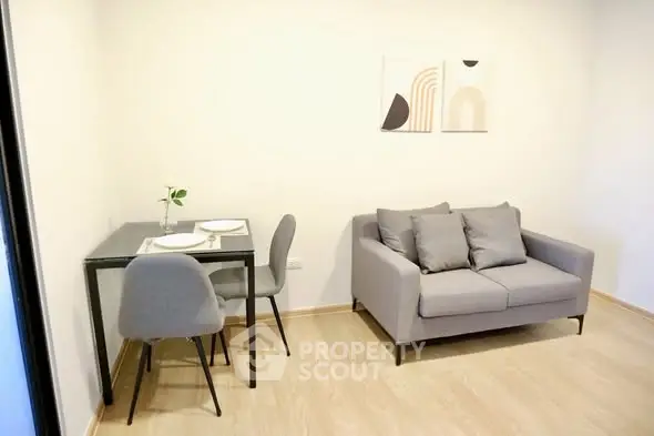 Modern living room with cozy sofa and dining area in minimalist style.