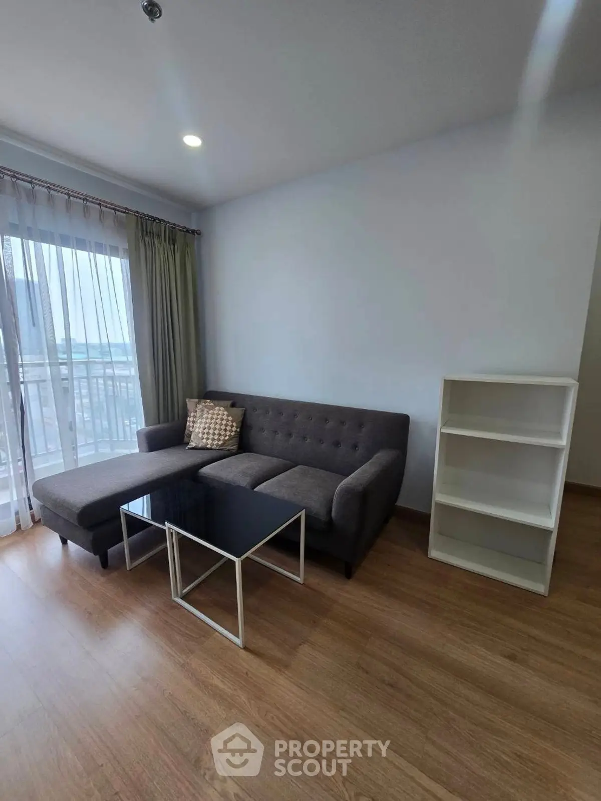 Modern living room with stylish sofa and natural light from large window