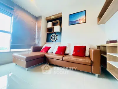 Modern living room with stylish brown leather sofa and decorative accents