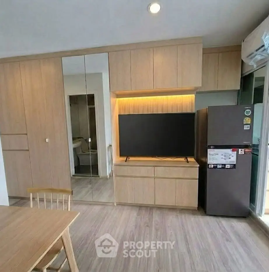 Modern apartment interior with sleek wooden cabinetry and integrated appliances