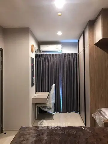 Modern bedroom with sleek design and ample storage in a stylish apartment.