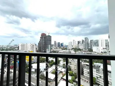 Stunning cityscape view from a high-rise balcony, showcasing urban skyline and vibrant city life.
