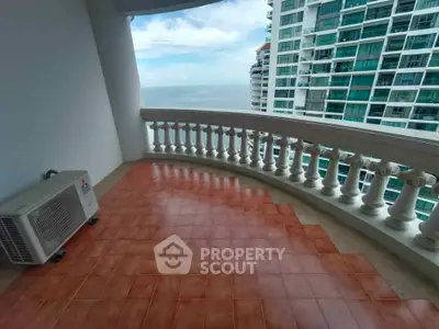 Spacious balcony with ocean view in modern high-rise building