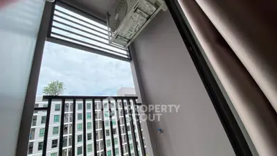 Modern apartment balcony with city view and air conditioning unit
