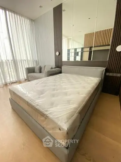 Spacious modern bedroom with large windows and stylish decor